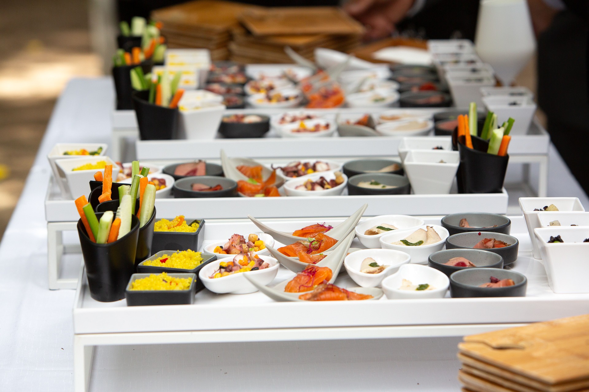 Catering service presenting a variety of appetizers on white trays