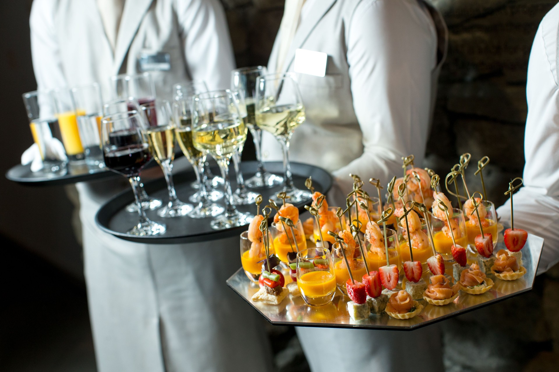 Canapes and wine on tray in waitor's hand